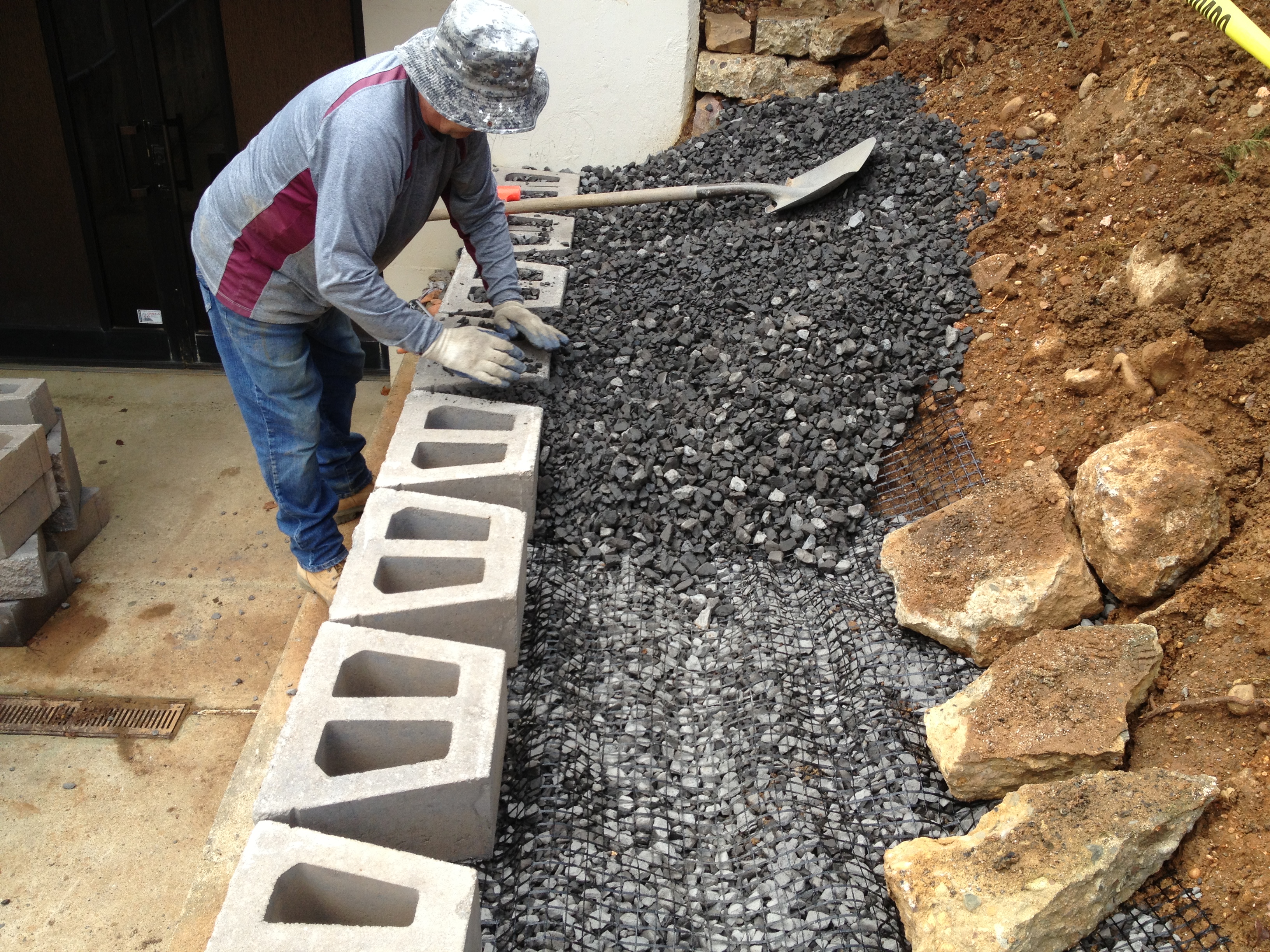 EP Henry retaining wall with capstones being set in Philadelphia